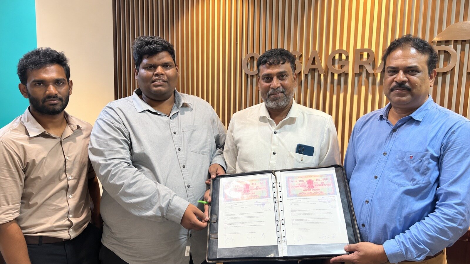 Bumblebee Inc and Casagrand representatives holding the signed BIM training partnership agreement at the Casagrand office.