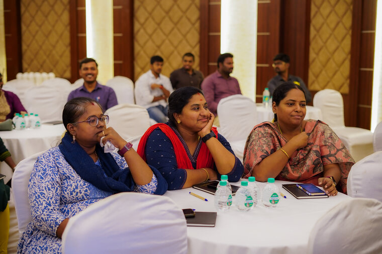 Three participants discussing the session material at a workshop table